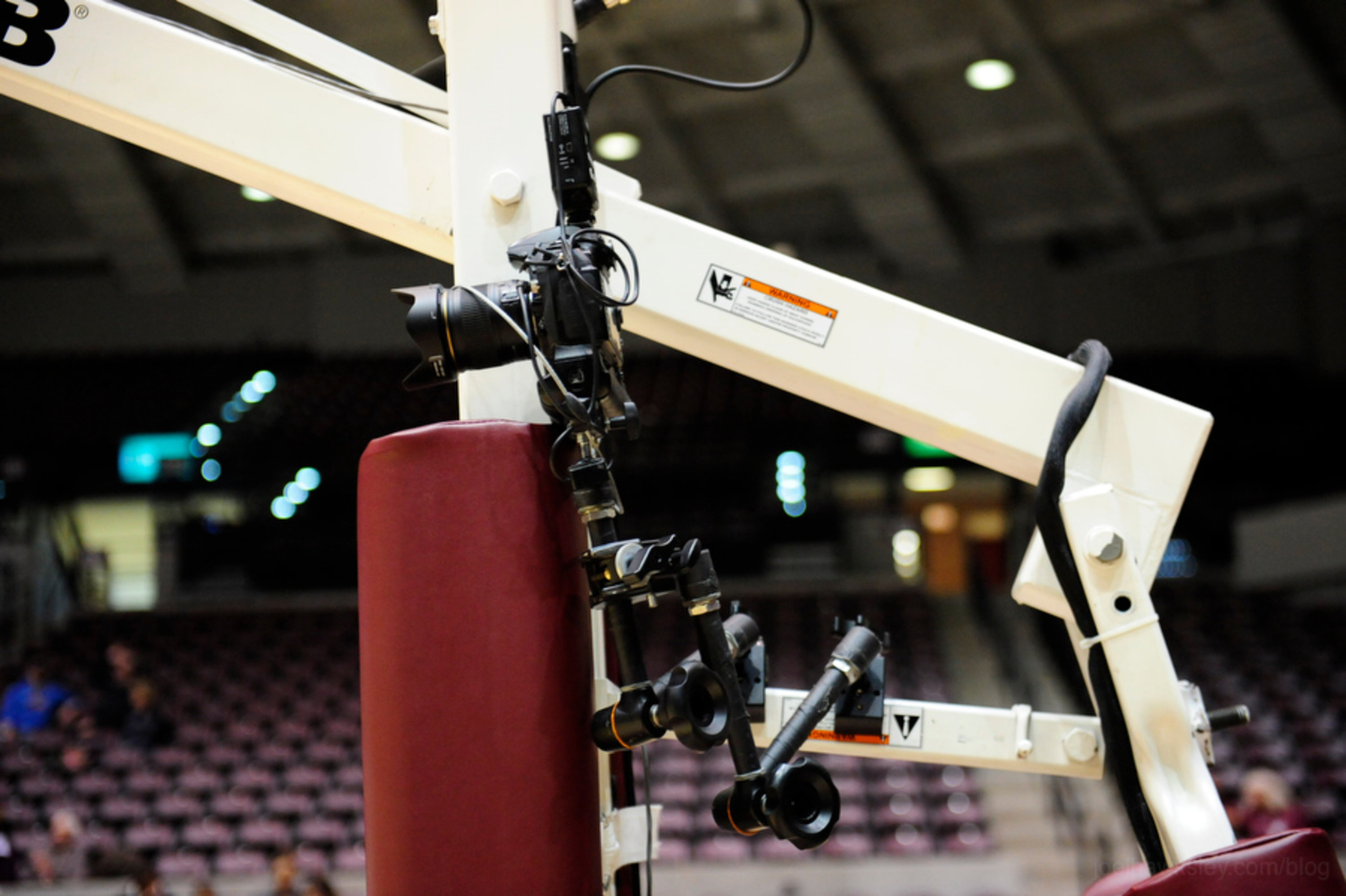 Nikon camera mounted to the post of a basketball hoop, viewed from the side